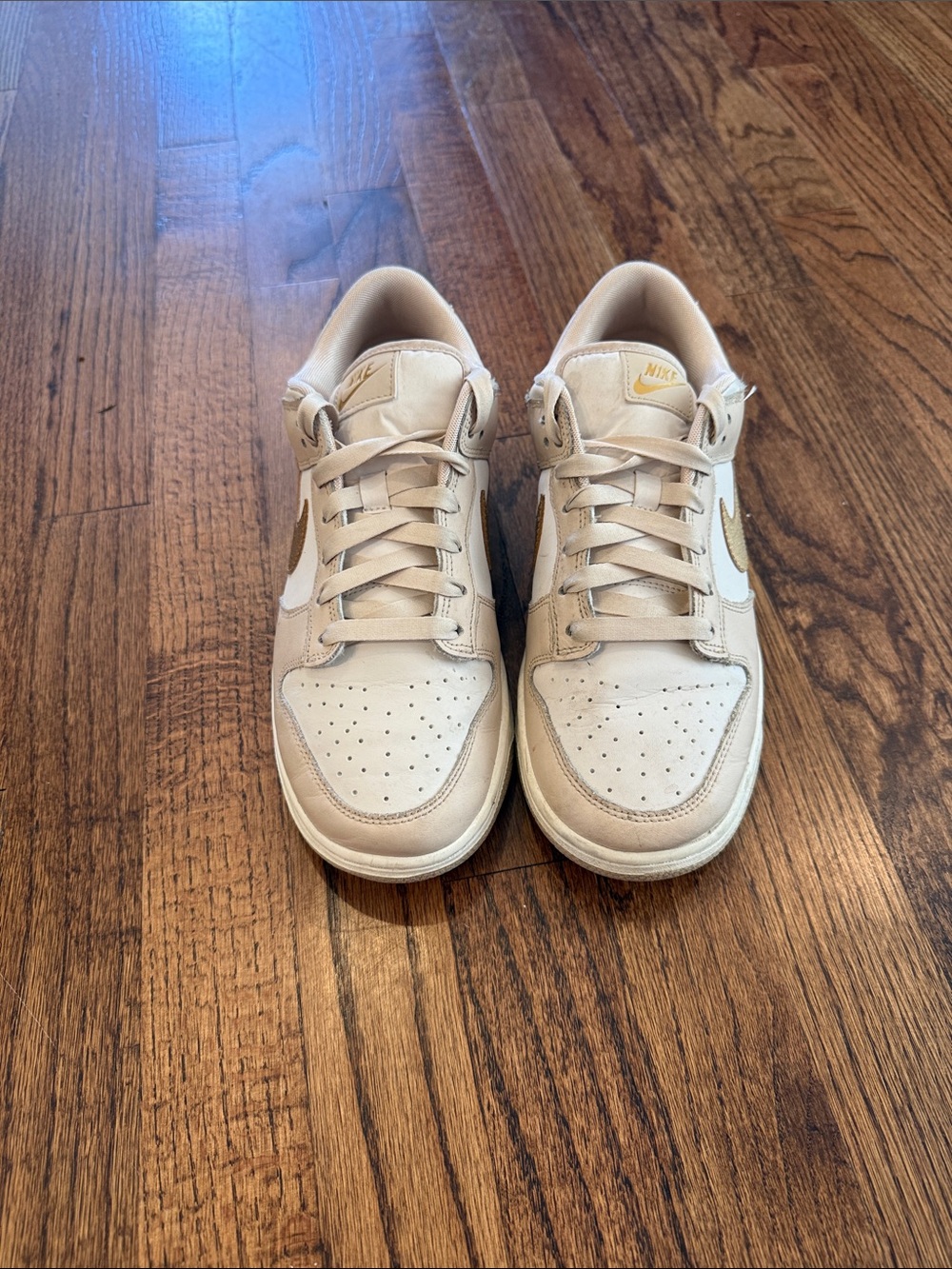Nike women’s Low-Top Sneakers in Cream and Gold Accents